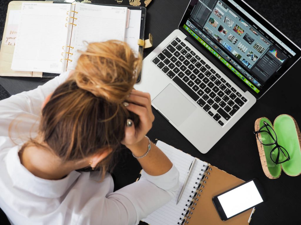 Woman stressed at work with laptop