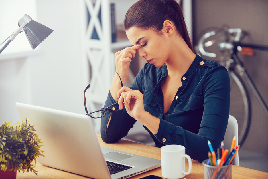 Woman stressed at work desk